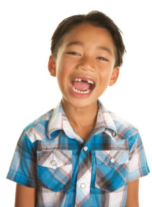young boy smiling with mouth wide open
